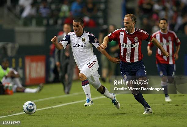 Luis Gil of Real Salt Lake paces the ball under pressure from Simon Elliott of Chivas USA during the MLS match at The Home Depot Center on August 27,...