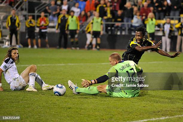 Goalkeeper Josh Saunders of the Los Angeles Galaxy makes a save on a shot from Andres Mendoza of the Columbus Crew as Frankie Hejduk of the Los...