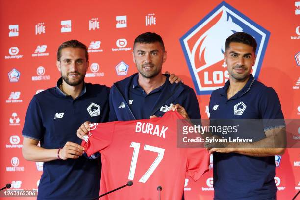 Burak Yilmaz poses for photographers with his compatriots Yusuf Yazıcı and Zeki Celik who are already part of the lille team during the presentation...