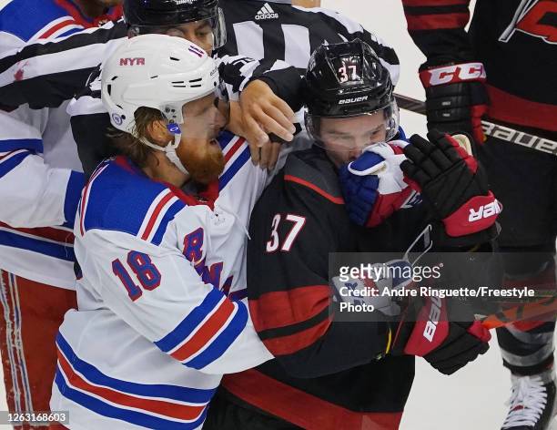 Marc Staal of the New York Rangers gets the glove up on Andrei Svechnikov of the Carolina Hurricanes during the first period in Game One of the...
