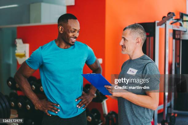 Trainer And Client Personal Trainer Talking To Client Photos and Premium High Res Pictures ...
