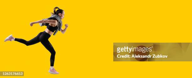 female athlete running on a yellow background. - sprinting bildbanksfoton och bilder