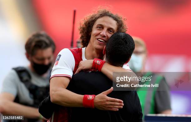 David Luiz of Arsenal embraces Mikel Arteta, Manager of Arsenal after their teams victory in the Heads Up FA Cup Final match between Arsenal and...