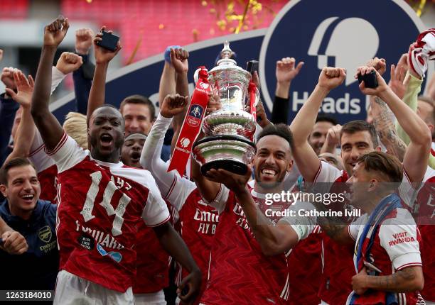 Pierre-Emerick Aubameyang of Arsenal lifts the FA Cup Trophy with his team mates after their victory in the Heads Up FA Cup Final match between...