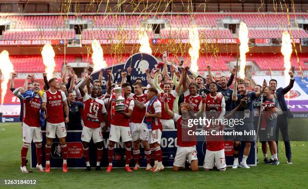 Pierre-Emerick Aubameyang of Arsenal lifts the FA Cup Trophy with his team mates after their victory in the Heads Up FA Cup Final match between...