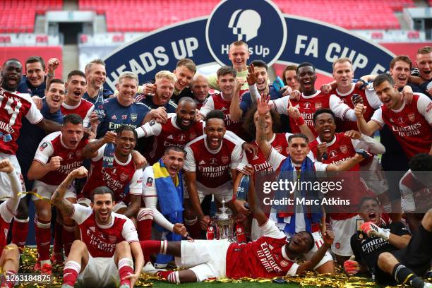 Arsenal players and staff celebrate with the FA Cup Trophy following their team's victory inthe FA Cup Final match between Arsenal and Chelsea at...