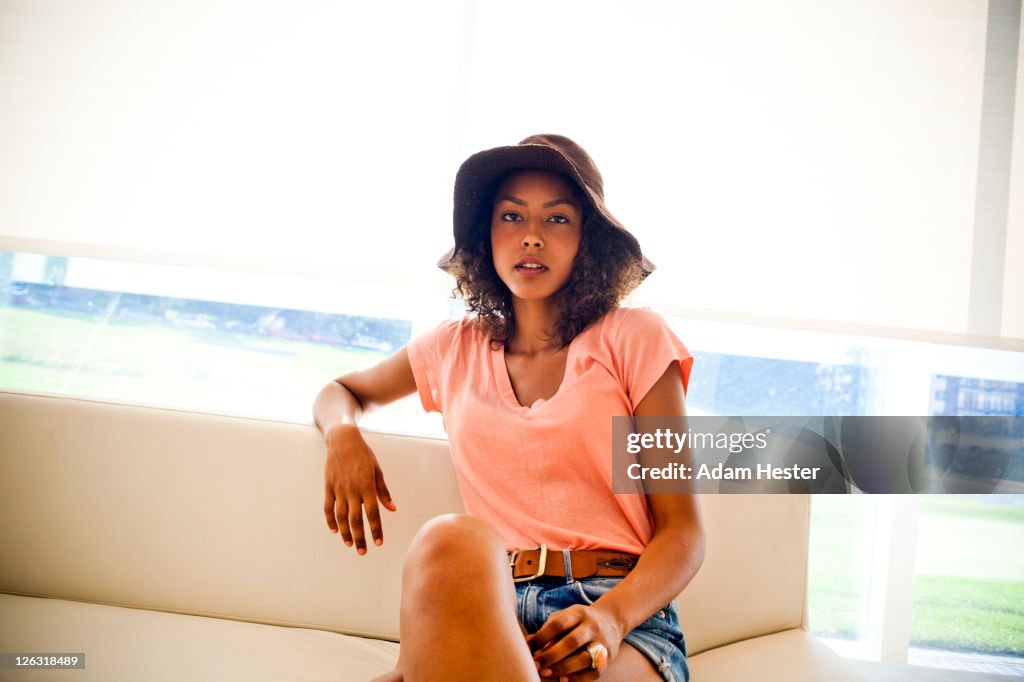 A young girl sitting inside a modern room.