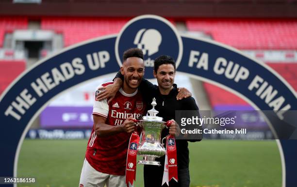 Pierre-Emerick Aubameyang of Arsenal poses with Mikel Arteta, Manager of Arsenal and the FA Cup Trophy after their teams victory in the Heads Up FA...
