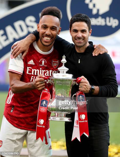 Pierre-Emerick Aubameyang of Arsenal poses with Mikel Arteta, Manager of Arsenal and the FA Cup Trophy after their teams victory in the Heads Up FA...