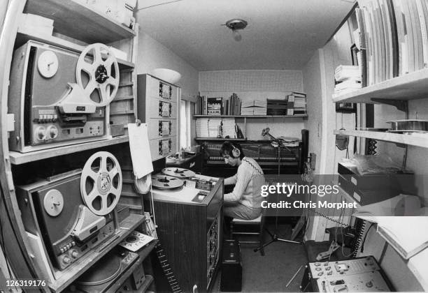 Photo of Pete TOWNSHEND and WHO, Pete Townshend, guitarist with The Who posed in home studio with instruments and recording equipment in 1969.