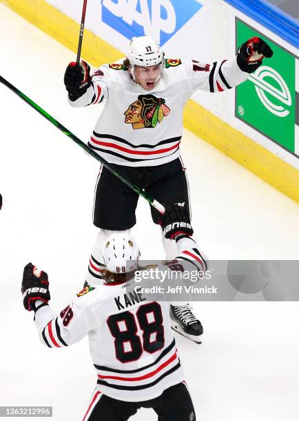 Dylan Strome of the Chicago Blackhawks celebrates his goal with teammate Patrick Kane in the first period against the Edmonton Oilers in Game One of...