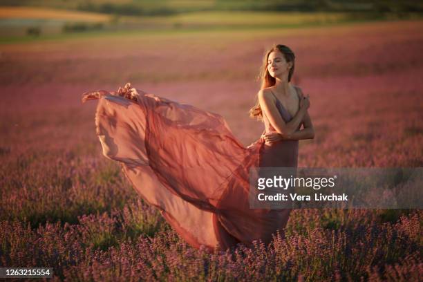 young pretty woman in  long waving skirt - skirt blowing ストックフォトと画像