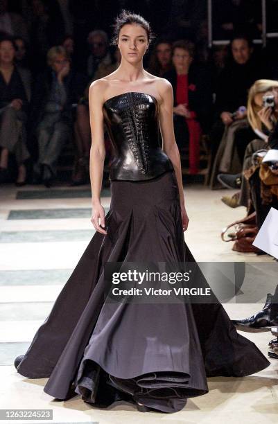 Mariacarla Boscono walks the runway during the Azzedine Alaia Haute Couture Spring/Summer 2003 fashion show as part of the Paris Haute Couture...