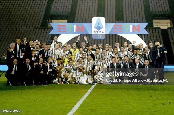 Juventus FC players and staff celebrate the winning of the Italian championship "scudetto" 2019-2020 with the trophy after the Serie A match between...