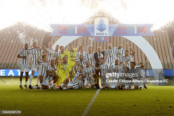 Juventus FC players celebrate the winning of the Italian championship "scudetto" 2019-2020 with the trophy after the Serie A match between Juventus...