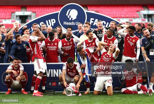 The team react as Pierre-Emerick Aubameyang of Arsenal drops the FA Cup Trophy during the celebrations after the FA Cup Final match between Arsenal...