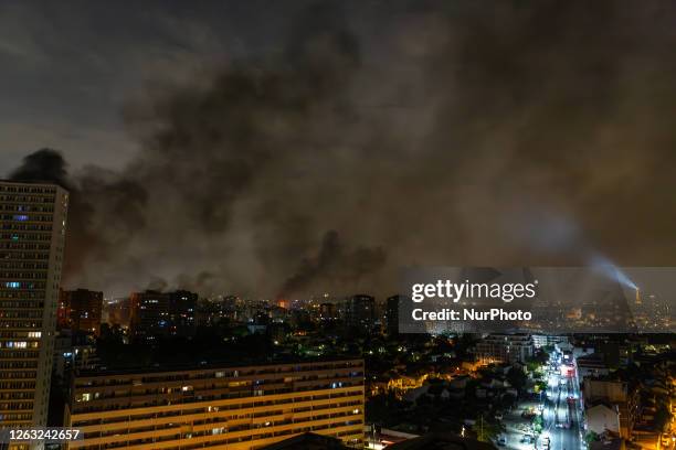 Columns of black smoke rose from the skies over the Paris region following a night of violence in many suburban towns, while the beacon of the Eiffel...