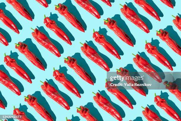 sweet long red marconi peppers on the blue background - piment photos et images de collection