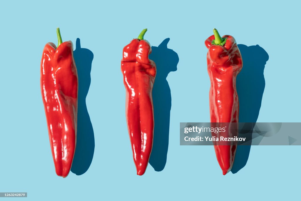 Sweet long red marconi peppers on the blue background