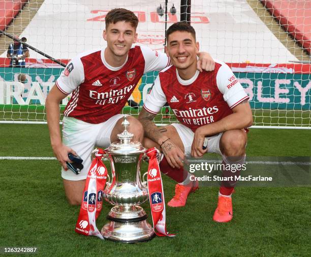 Kieran Tierney and Hector Bellerin of Arsenal pose for photos with the trophy after the FA Cup Final match between Arsenal and Chelsea at Wembley...