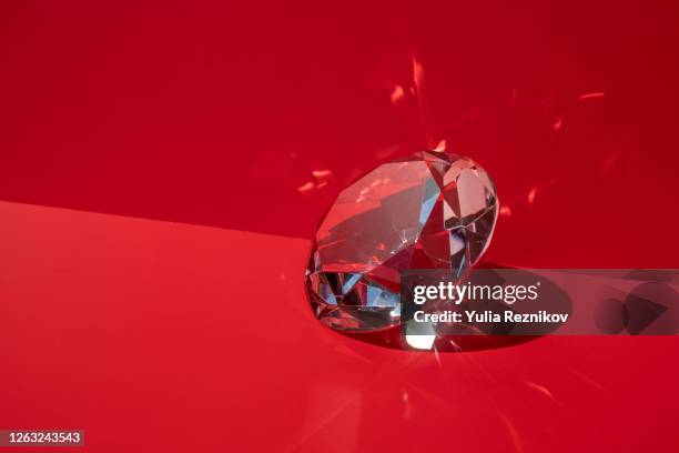 shiny diamond on the red background - diamantvorm stockfoto's en -beelden