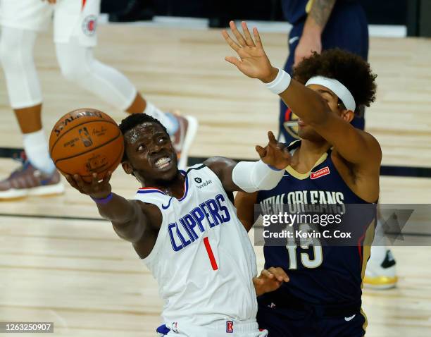 Reggie Jackson of the LA Clippers shoots against Frank Jackson of the New Orleans Pelicans at HP Field House at ESPN Wide World Of Sports Complex on...