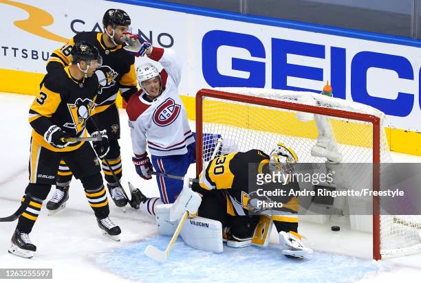 Jesperi Kotkaniemi of the Montreal Canadiens celebrates his goal as Matt Murray of the Pittsburgh Penguins looks at the puck in Game One of the...
