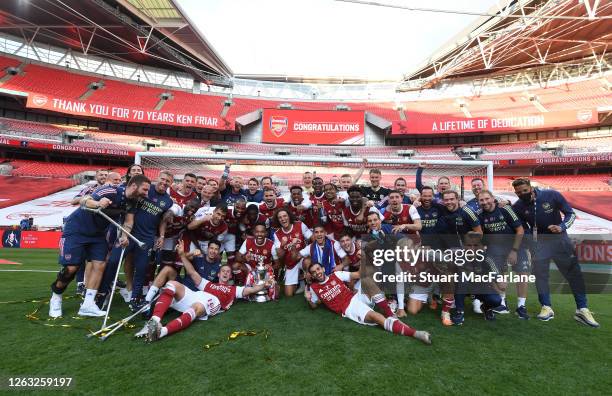 The Arsenal players and staff celebrate after the FA Cup Final match between Arsenal and Chelsea at Wembley Stadium on August 01, 2020 in London,...