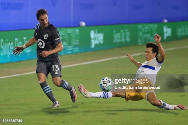 Ethan Finlay of Minnesota United fights for the ball with Danny Hoesen of San Jose Earthquakes during a quarter final match of MLS Is Back Tournament...