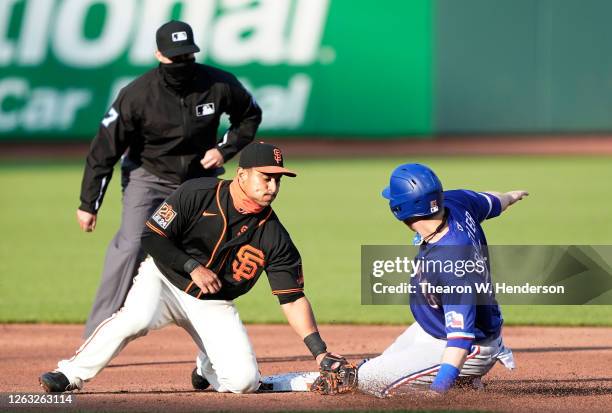 Todd Frazier of the Texas Rangers steals second base sliding in ahead of the tag of Donovan Solano of the San Francisco Giants in the top of the...