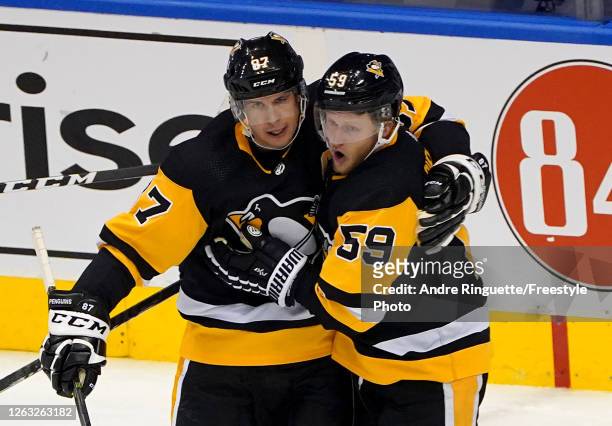 Sidney Crosby of the Pittsburgh Penguins celebrates his goal with teammate Jake Guentzel in the second period against the Montreal Canadiens in Game...