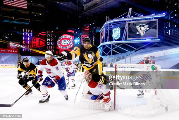 Conor Sheary of the Pittsburgh Penguins falls to the ice after colliding with goaltender Carey Price of the Montreal Canadiens drawing a penalty shot...