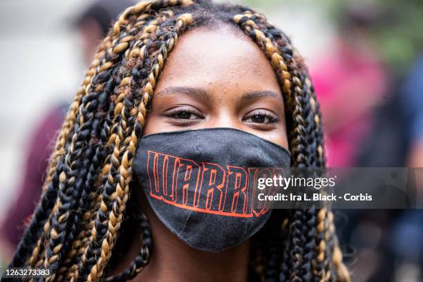 Kiara Williams an organization leader with The Warriors in The Garden wears a mask that says, "Warriors" at the protest in Bayside, Queens. This...