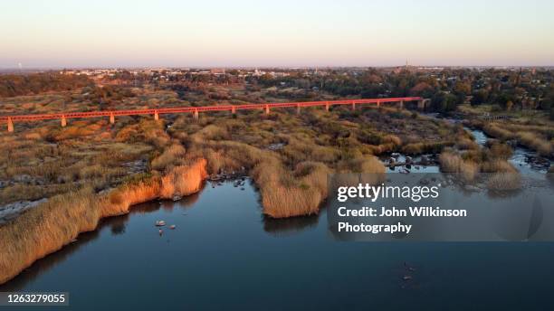railway bridge over the orange river in upington - upington stock-fotos und bilder