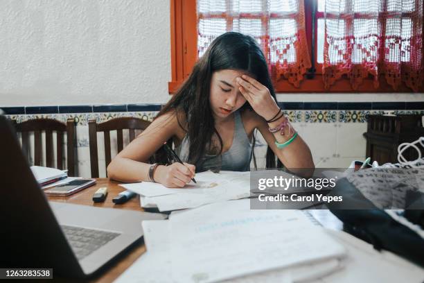 female teenager feeling stressed studing at home.e learning.home schooling - e girls stock pictures, royalty-free photos & images