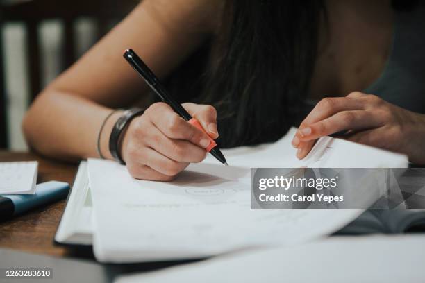 closeup teenager boy doing homework - studio legale foto e immagini stock
