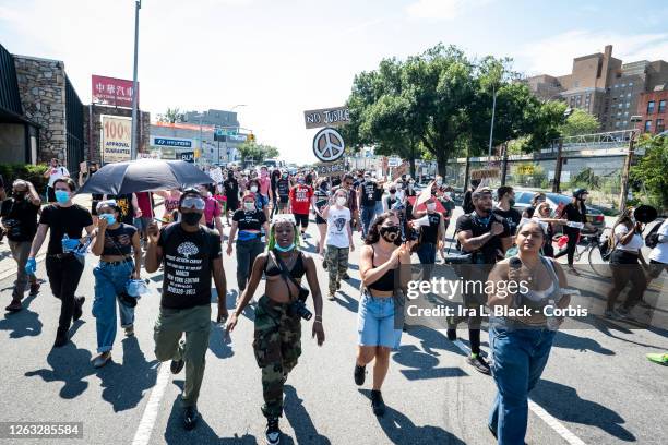 Members of the Warriors in the Garden lead a crowd of protesters as they walk through neighborhoods during the Black Lives Matter protest in Bayside,...