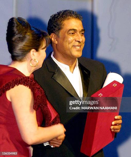 Egyptian actor Ahmed Zaki is congratulated by actress Elham Shahin 25 October 2002 in Cairo after he won the best actor award at the 26 Cairo...