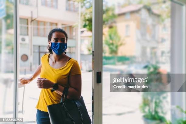 businesswoman with protective mask during covid-19 - entering stock pictures, royalty-free photos & images