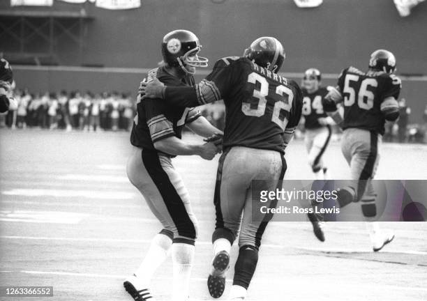 Terry Bradshaw, Quarterback, congratulates Franco Harris, running back of the Pittsburgh Steelers during the December 22, 1974 playoff game between...