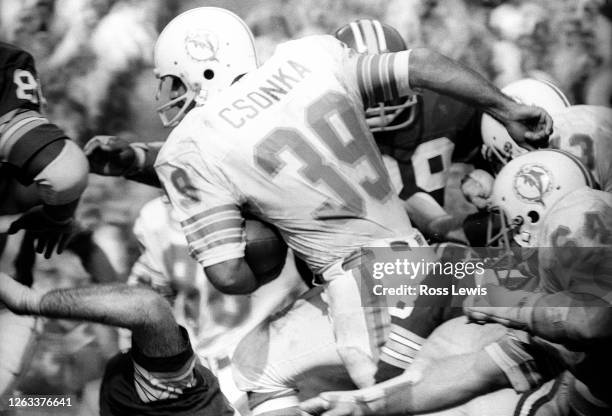 Larry Csonka, fullback of the Miami Dolphins carries the football during an NFL game between the Miami Dolphins and Washington Redskins at Robert F....
