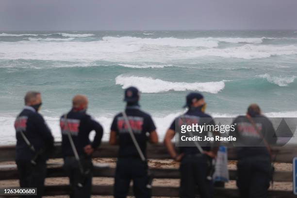 Palm Beach County Fire Rescue check out the ocean as waves crash ashore from Tropical Storm Isaias as it passes through the area on August 02, 2020...