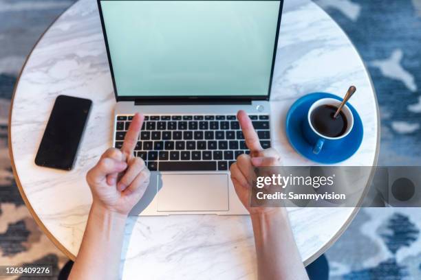 directly above view of a man working on laptop in bedroom - v sign stock pictures, royalty-free photos & images