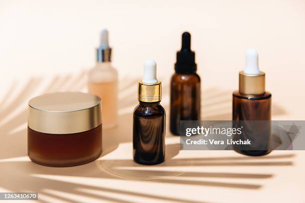 spa cosmetics in brown glass bottles on broun background. copy space for text. beauty blogger, salon therapy, branding mockup, minimalism concept. various facial massage oils for spa treatment. - hair products ストックフォトと画像