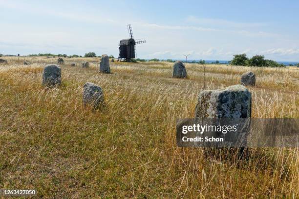 an old burial ground with a windmill on a sunny summer day - oland stock-fotos und bilder