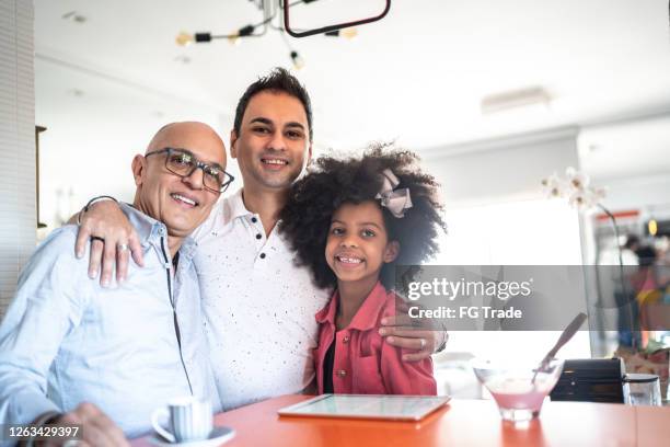 portrait of a happy family embracing at home - foster care stock pictures, royalty-free photos & images