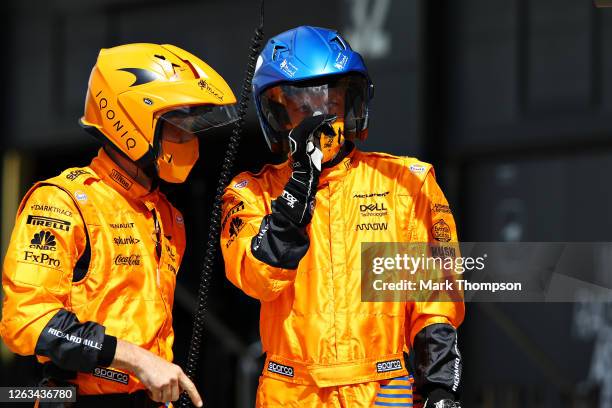 McLaren pit crew members talk in the Pitlane during the F1 Grand Prix of Great Britain at Silverstone on August 02, 2020 in Northampton, England.