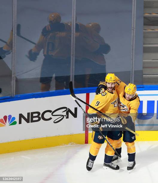 Filip Forsberg of the Nashville Predators celebrates his power-play goal at 19:57 of the first period against the Arizona Coyotes and is joined by...