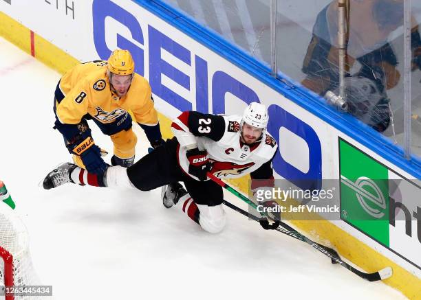 Oliver Ekman-Larsson of the Arizona Coyotes is tripped up by Kyle Turris of the Nashville Predators during the second period in Game One of the...