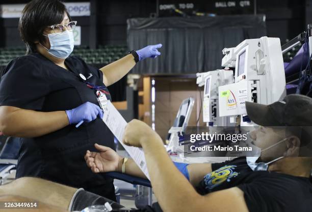 Phelbotomist Yaranely Armendariz speaks with Juan Aguirre after he donated blood at the 'El Paso Strong Memorial Blood Drive' in remembrance of the...